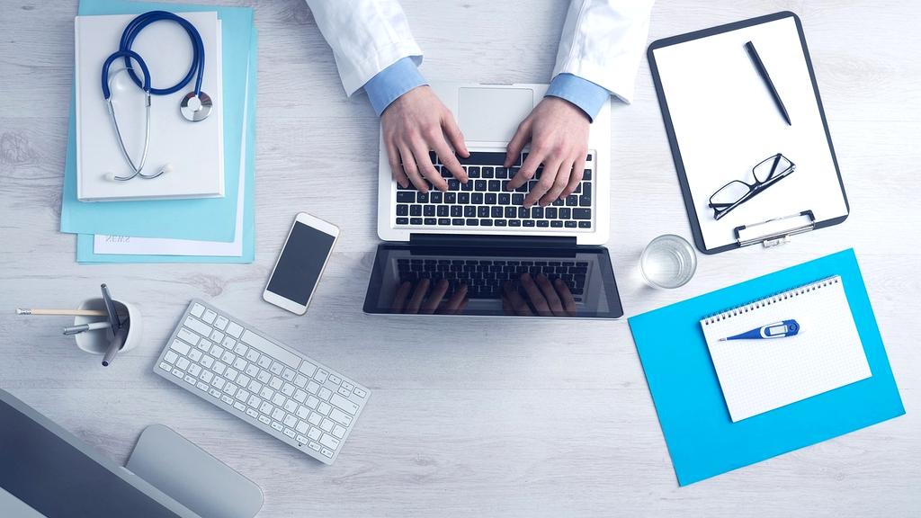 Healthcare professional using AI voice technology for telemedicine consultations